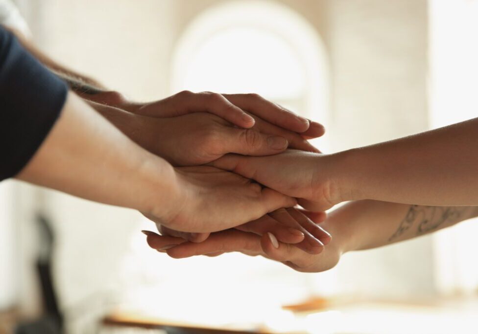 Close up of caucasian male and female hands, covering one another, shaking. Concept of business, finance, job. Copyspace for ad. Education, communication and freelance. Teambuilding, support.