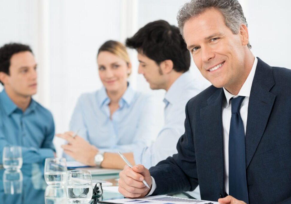 Portrait Of Successful Smiling Mature Businessman Looking At Camera